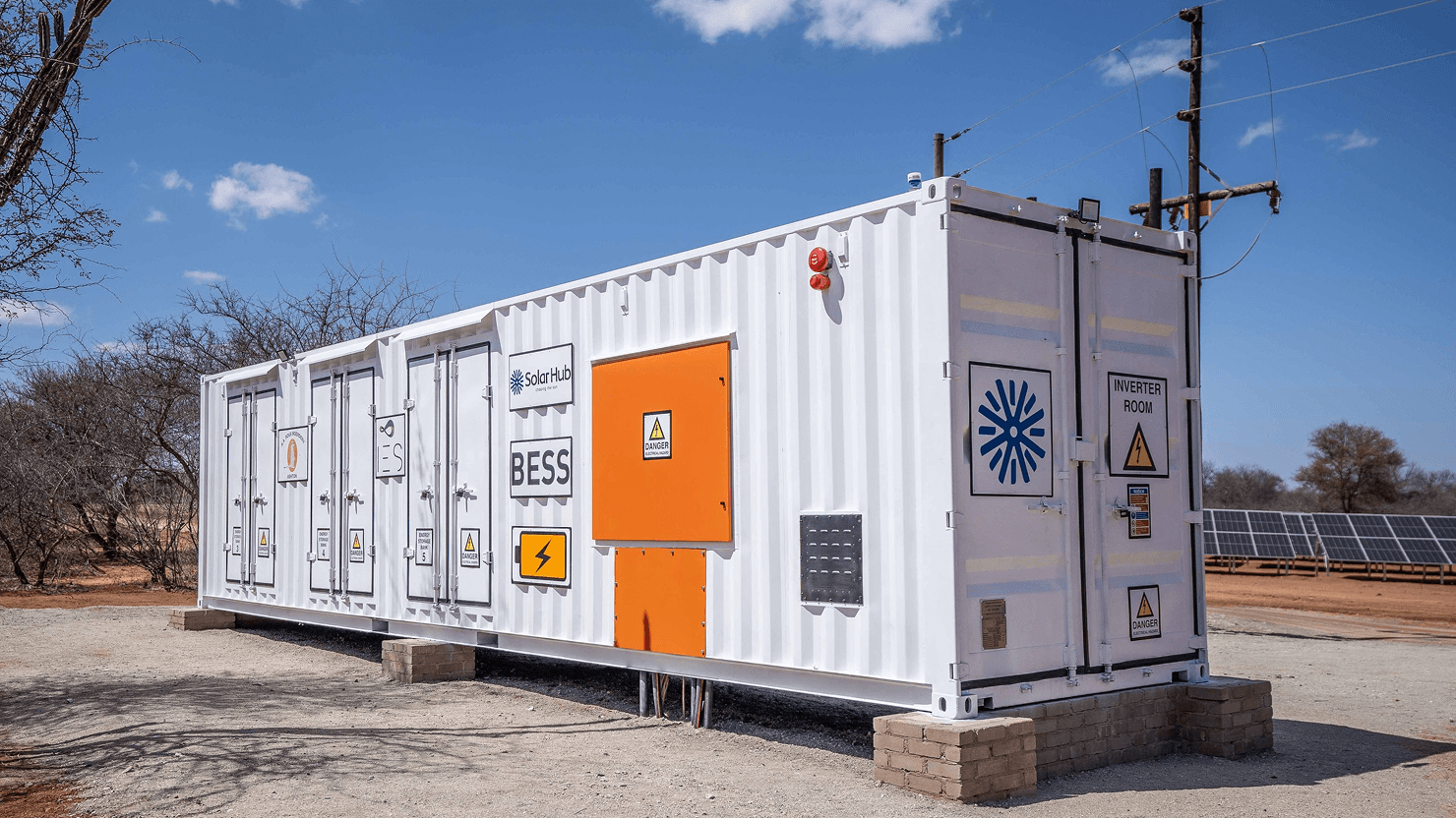 A man and a woman, both in business attire, are engaged in a serious discussion at a table with documents. The setting conveys a professional tone.