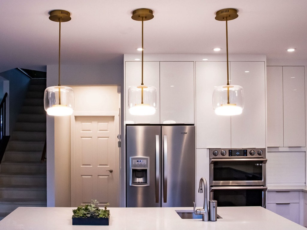 Image of Modern kitchen design with island, stainless appliances, and pendant lights by KHD Homes design-build construction.