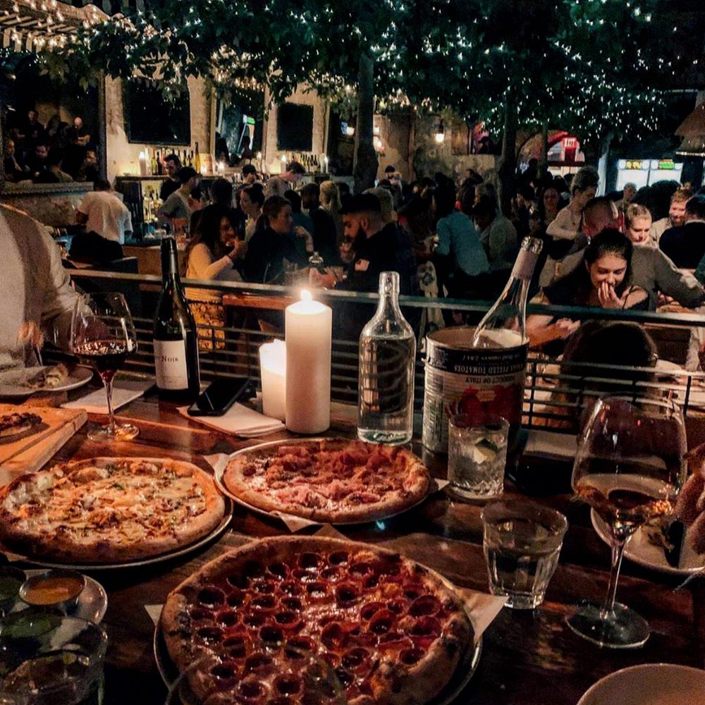 Pizzass in a dim restourant setting
