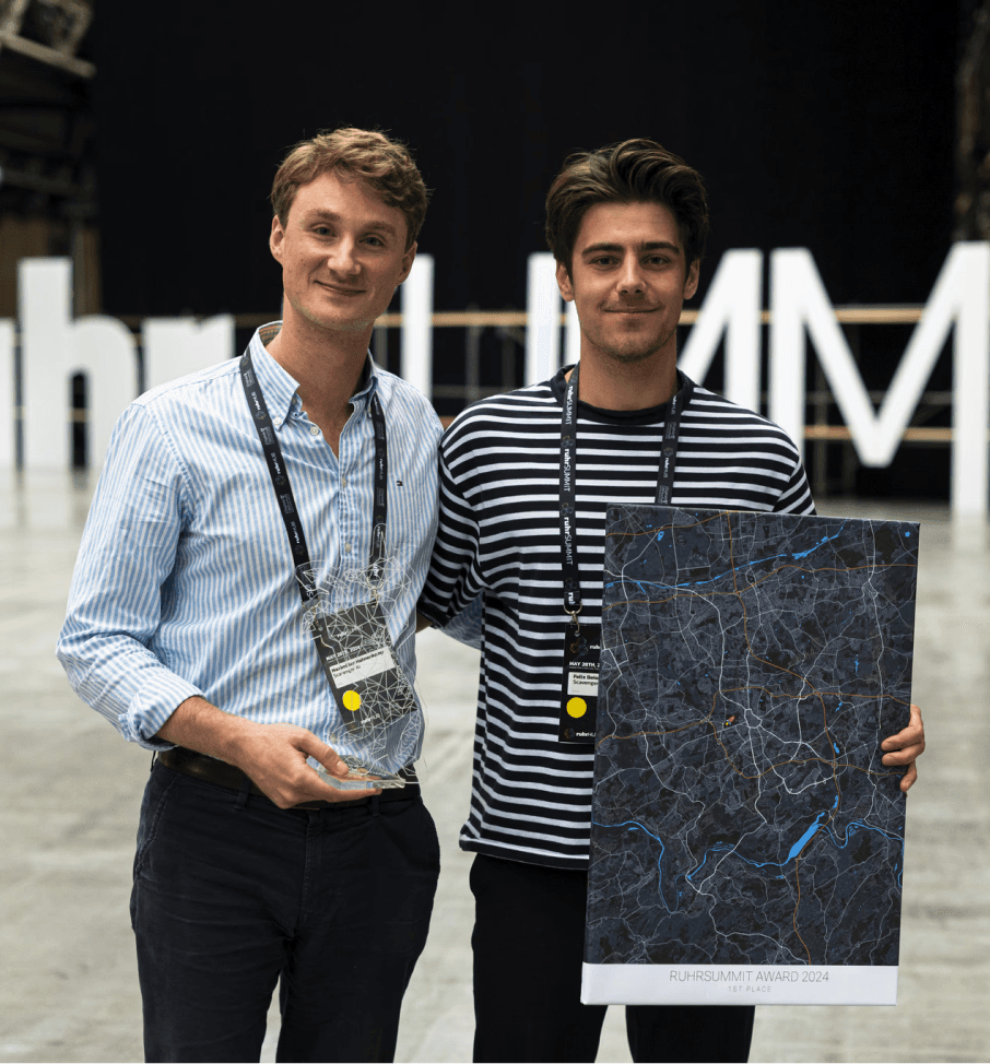 two men standing arm in arm with a map in their hands
