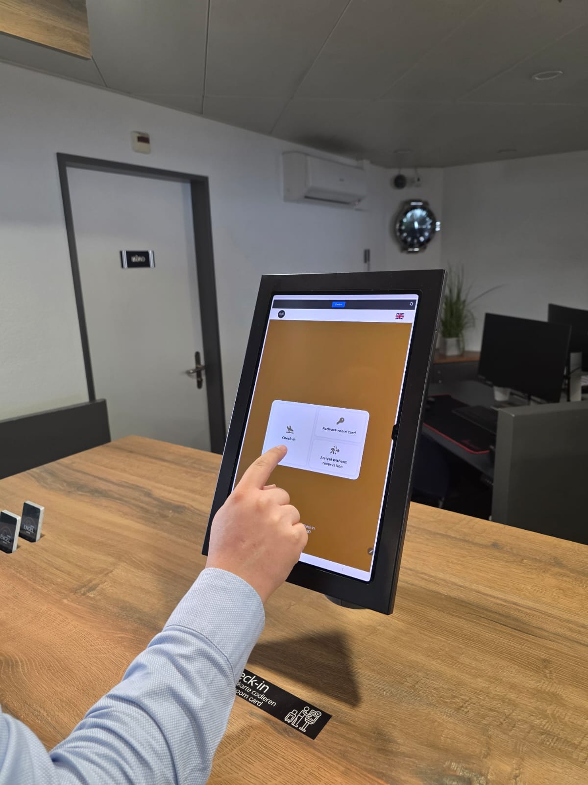 Gast führt Check-In an der Rezeption mit dem Tablet durch