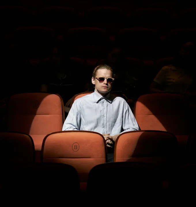 man-sitting-in-cinema-seat-spotlight