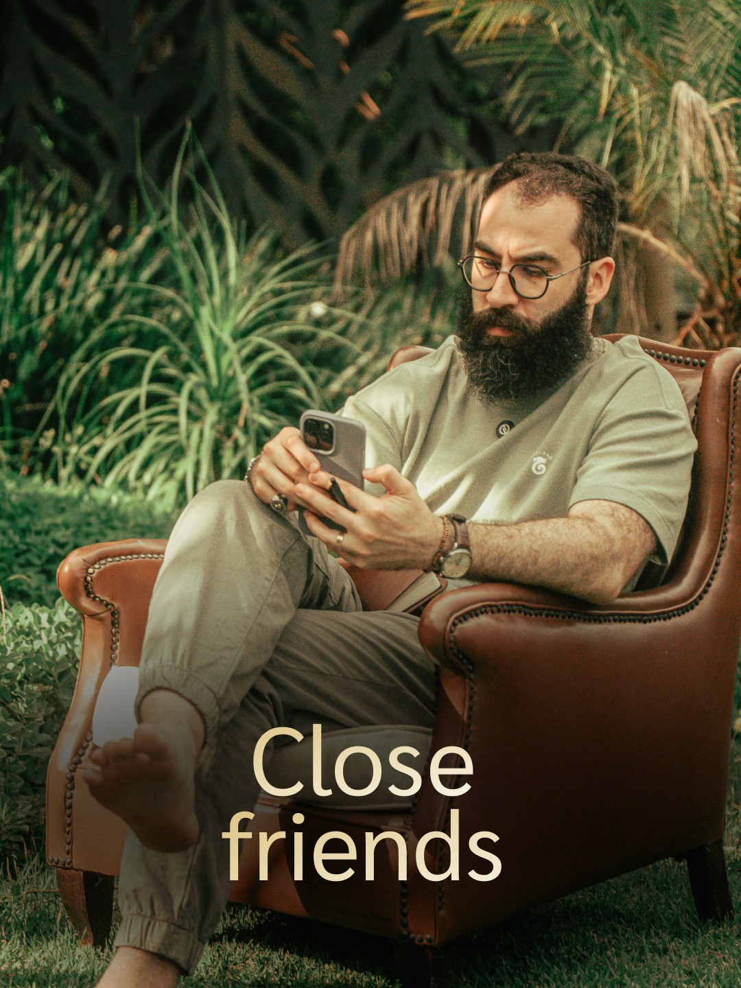 Dirt road flanked by vineyards and cypress trees, rolling hills, mist, and distant town in Tuscany.