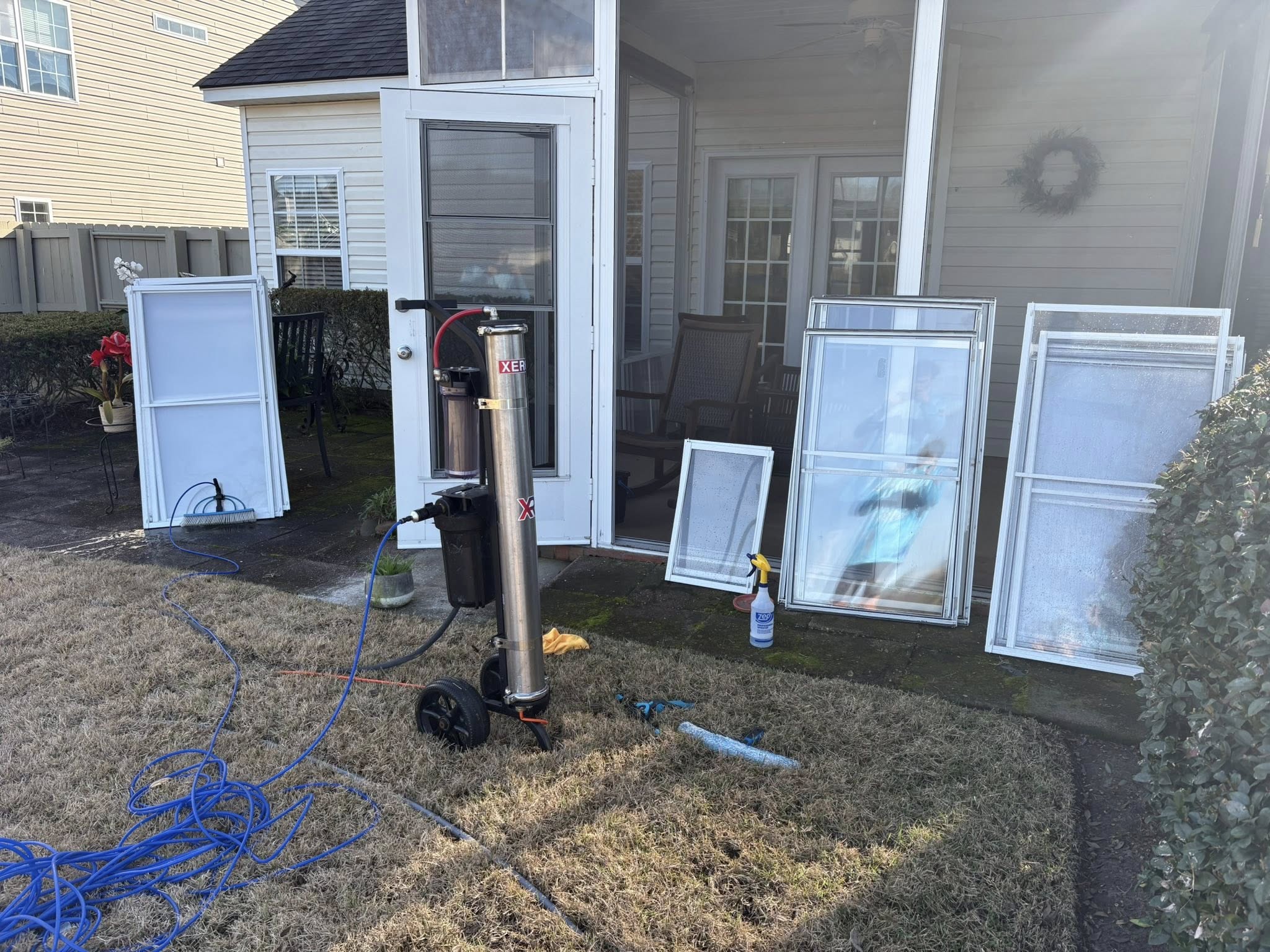 man in gray hoodie and blue denim jeans standing on brown wooden parquet flooring
