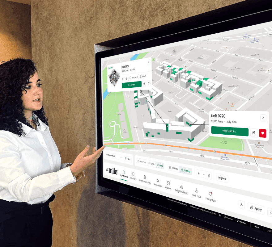 Leasing agent giving a tour using a large interactive touchscreen.