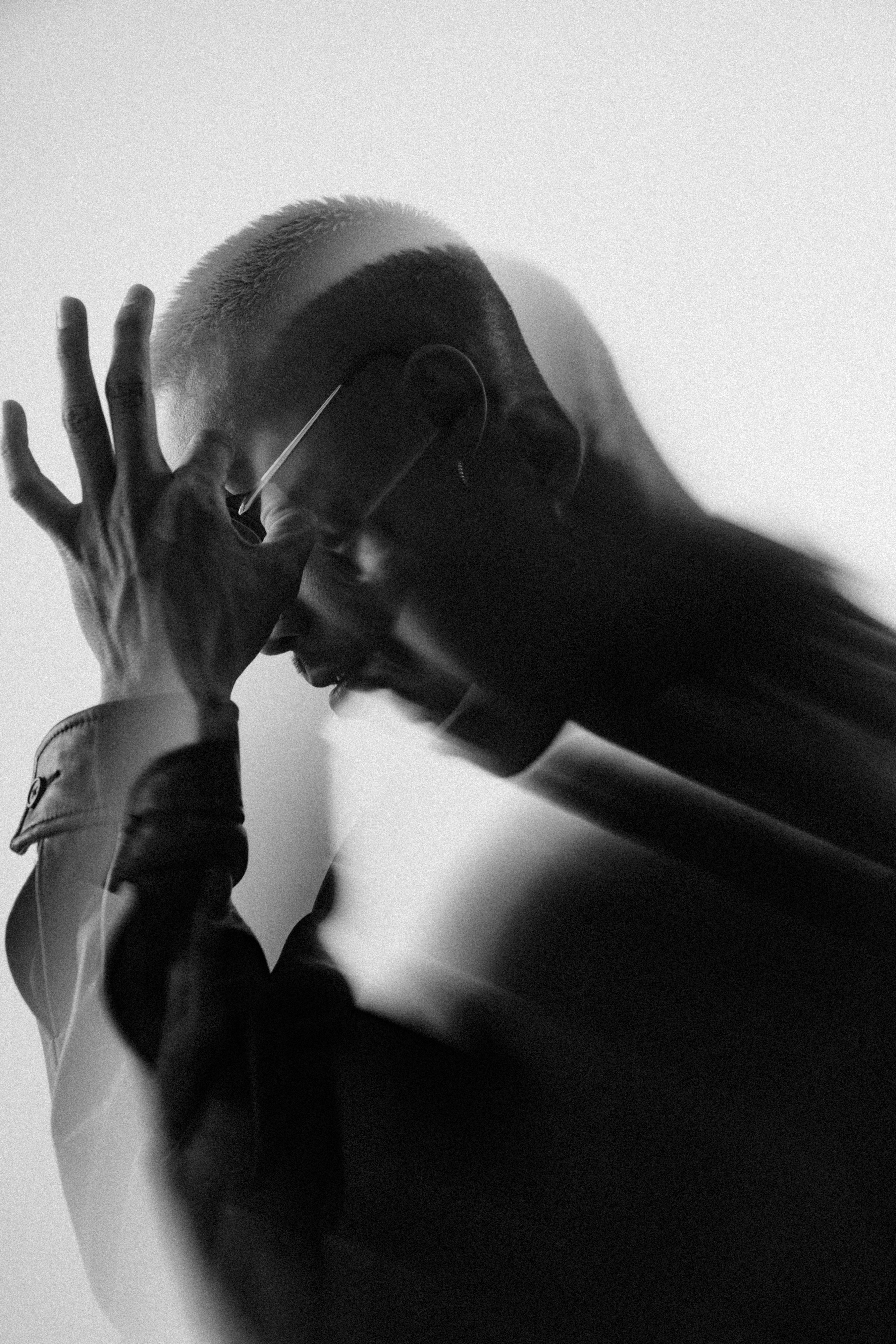 Man with hands on head, blurred motion effect.