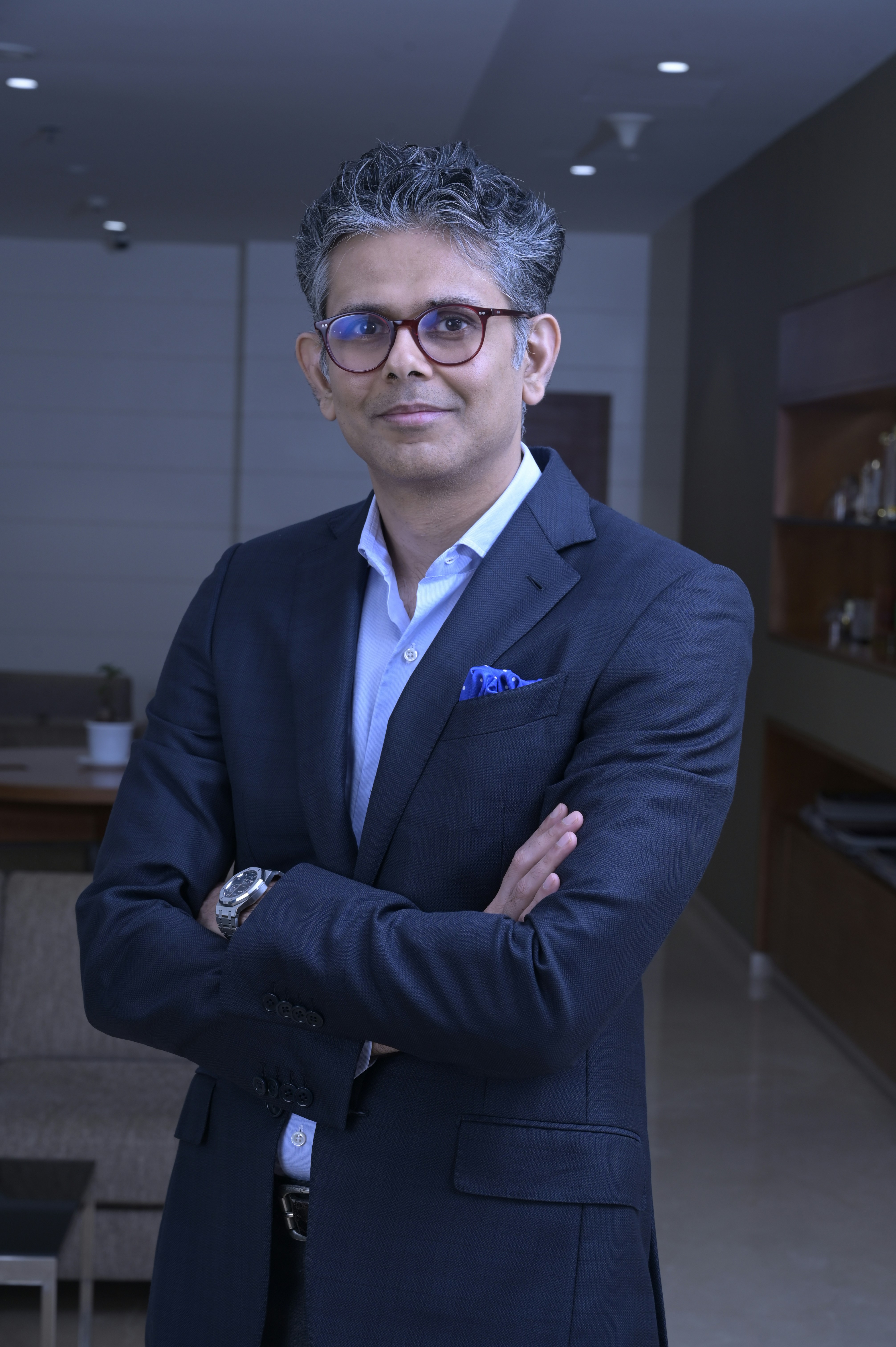 Man in suit with arms crossed looking at camera