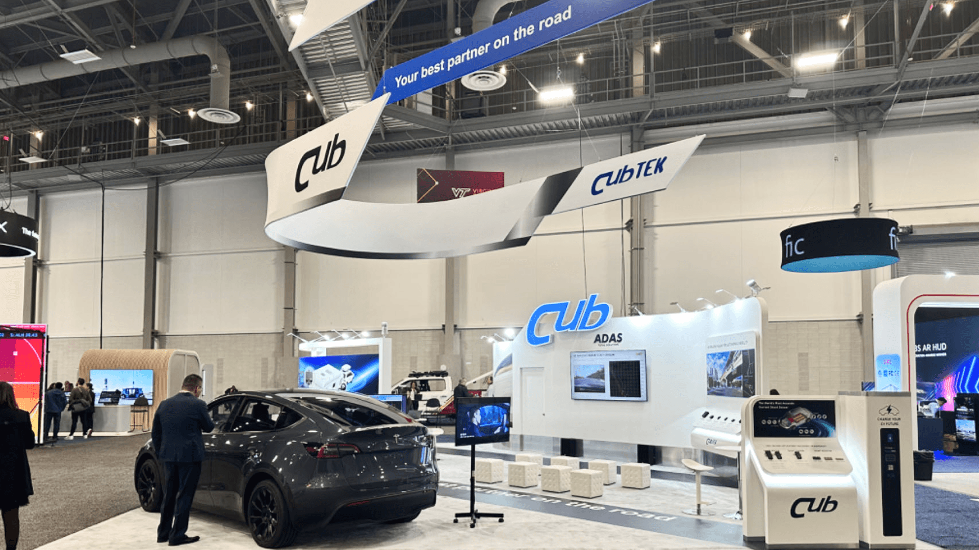 EV infrastructure zone showcasing charging piles and energy storage solutions on a white raised platform.
