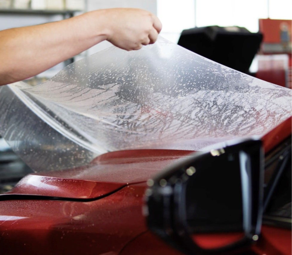 A man tinting a cars rear window
