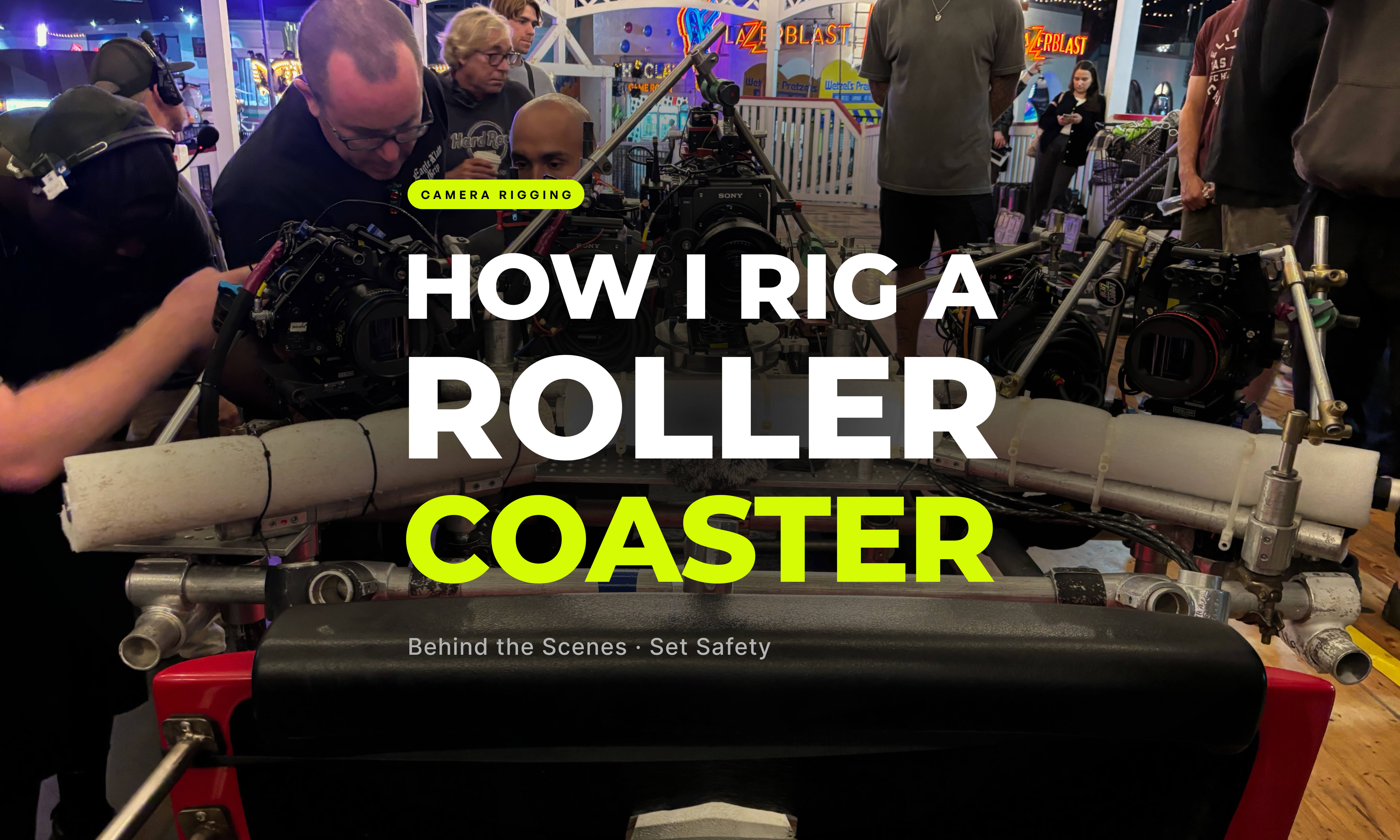 Three Sony cameras and an LED light panel mounted on a speedrail and cheeseplate rig on a roller coaster car at Belmont Park during a night shoot, with foam vibration padding visible and film crew surrounding the setup