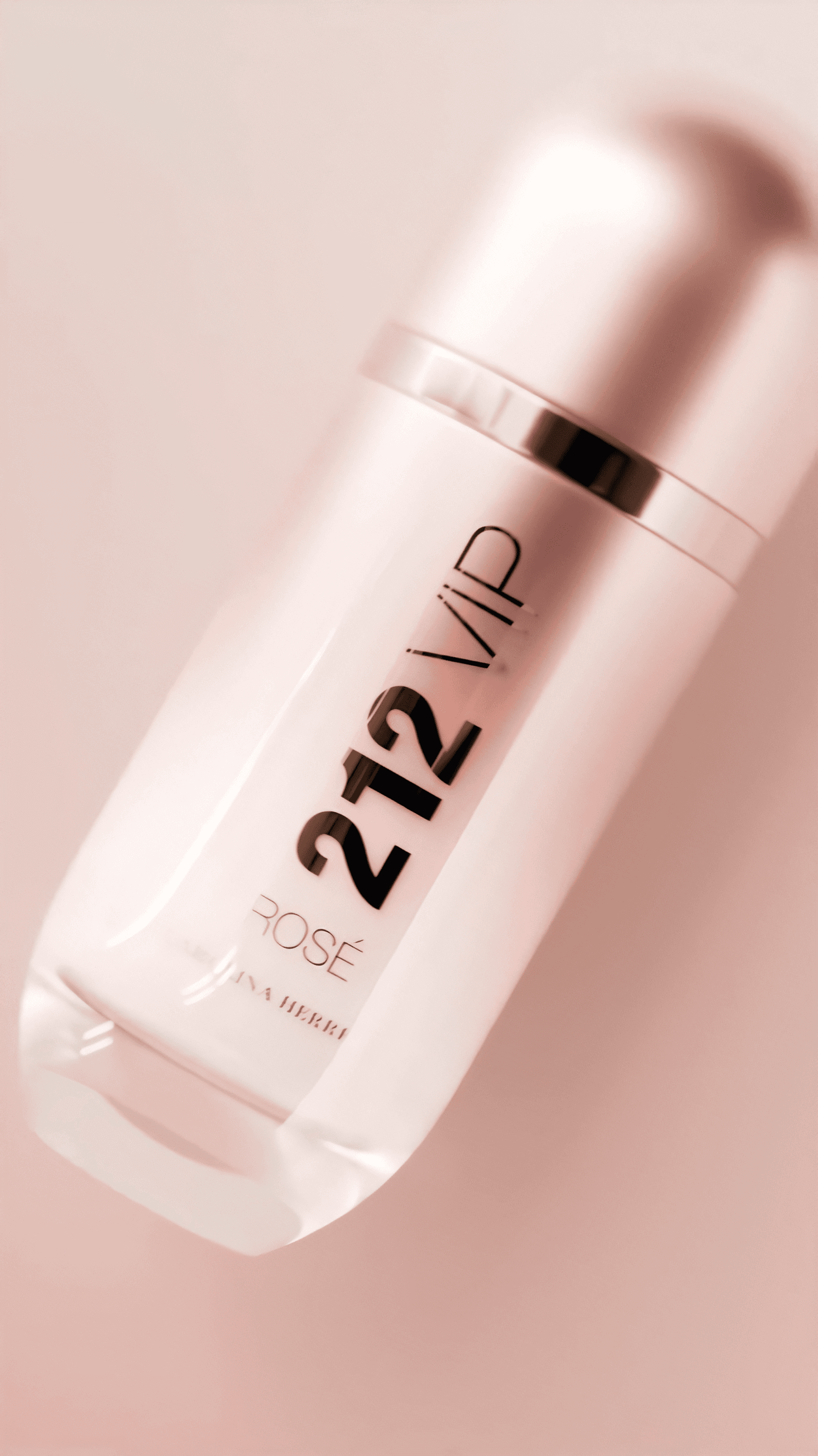 A close-up shot of the elegant, metallic pink "212 VIP Rosé" perfume bottle