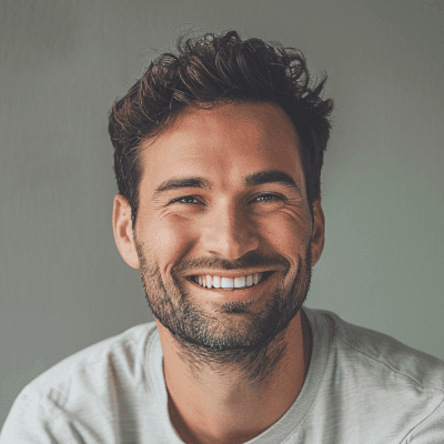 Dark-haired man with beard, wide smile, soft daylight, landscaping testimonial portrait