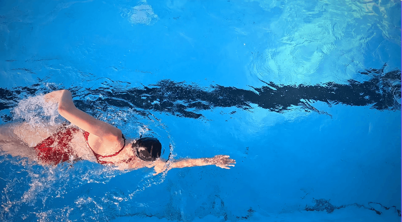 Close-up of a person meditating cross-legged indoors