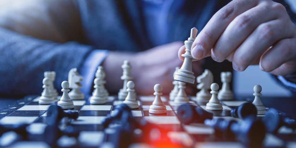 depth of field photography of man playing chess