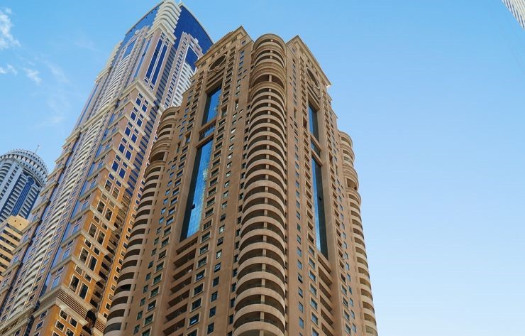 Low-angle view of Marina Crown skyscraper. Contact our property experts for luxury living in this iconic tower.