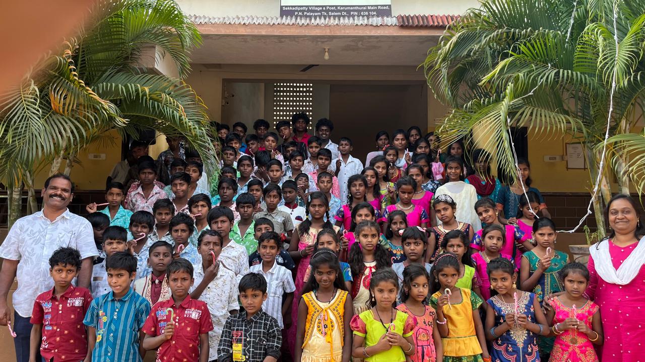 a group of children sitting on steps in front of a building