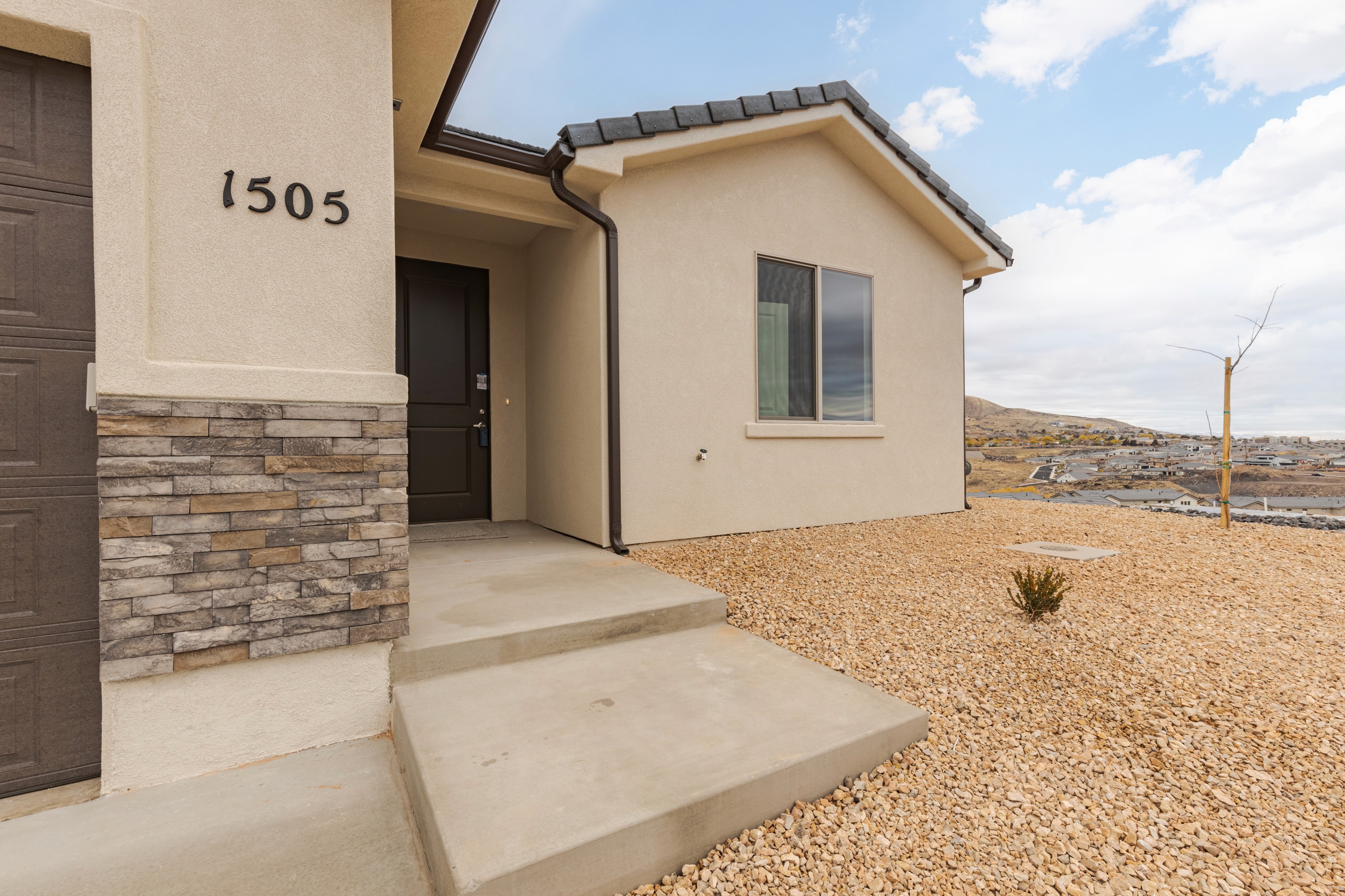 Front entry view of the Painted Sands twin home in Hurricane, Utah with an inviting doorway and architectural details.
