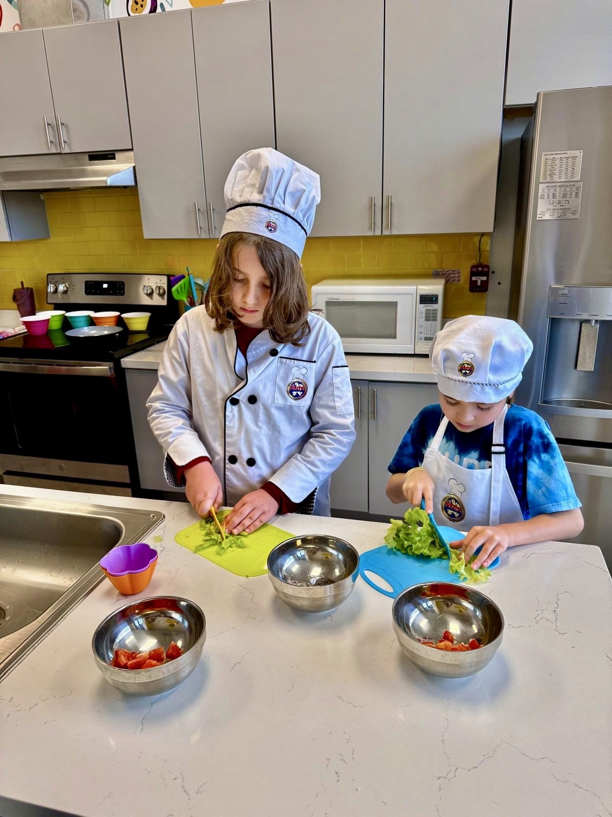 Kids cutting up veggies for a new recipe