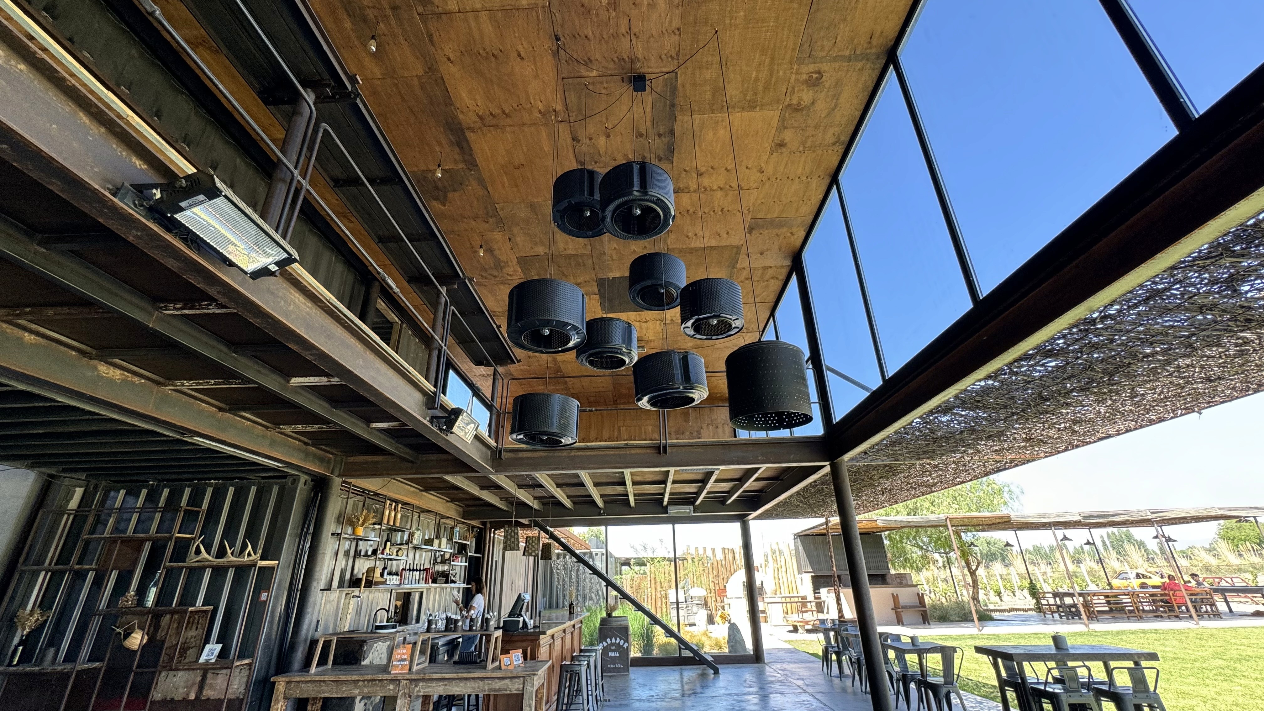 Interior of the MAAL Wines tasting room, built with reused shipping containers and washing-machine drums repurposed as ceiling lights