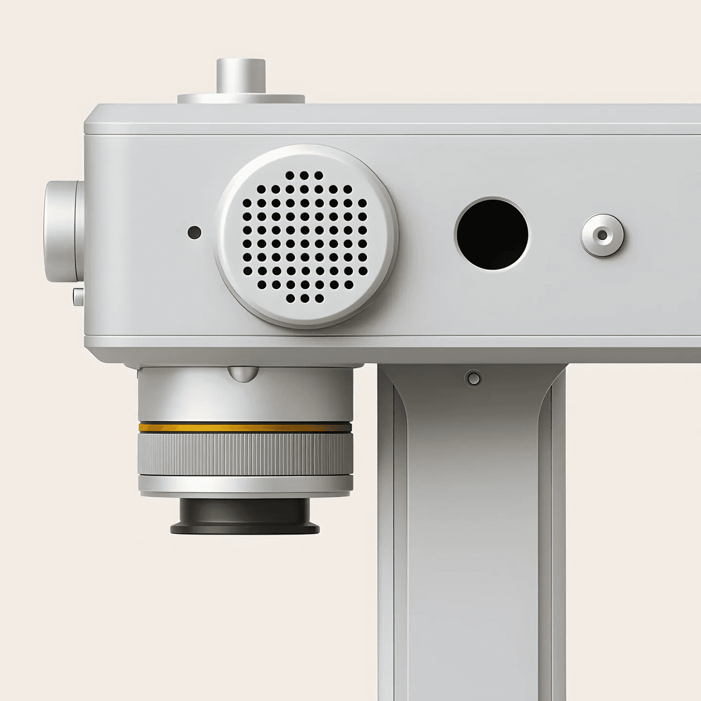 Close up of silver industrial device with perforated grille and lens opening