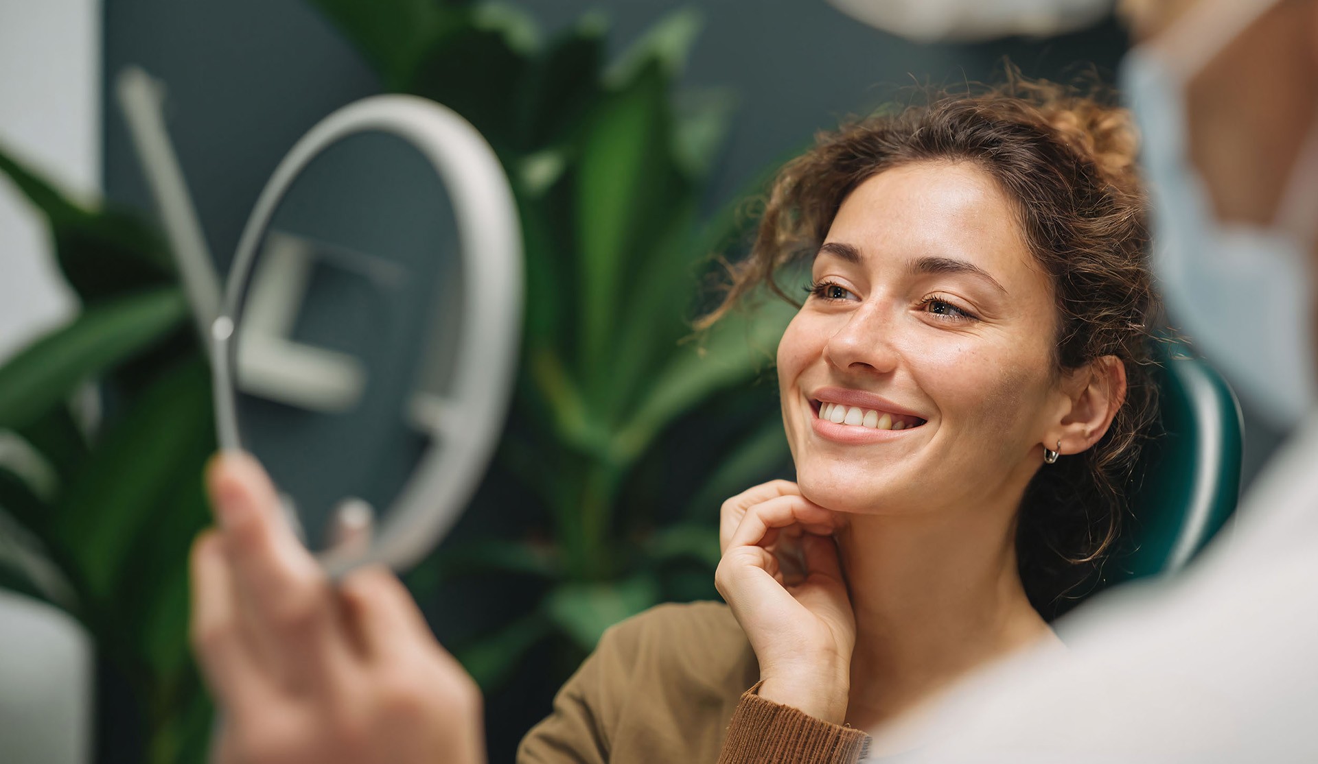 woman looking in a mirror and smiling