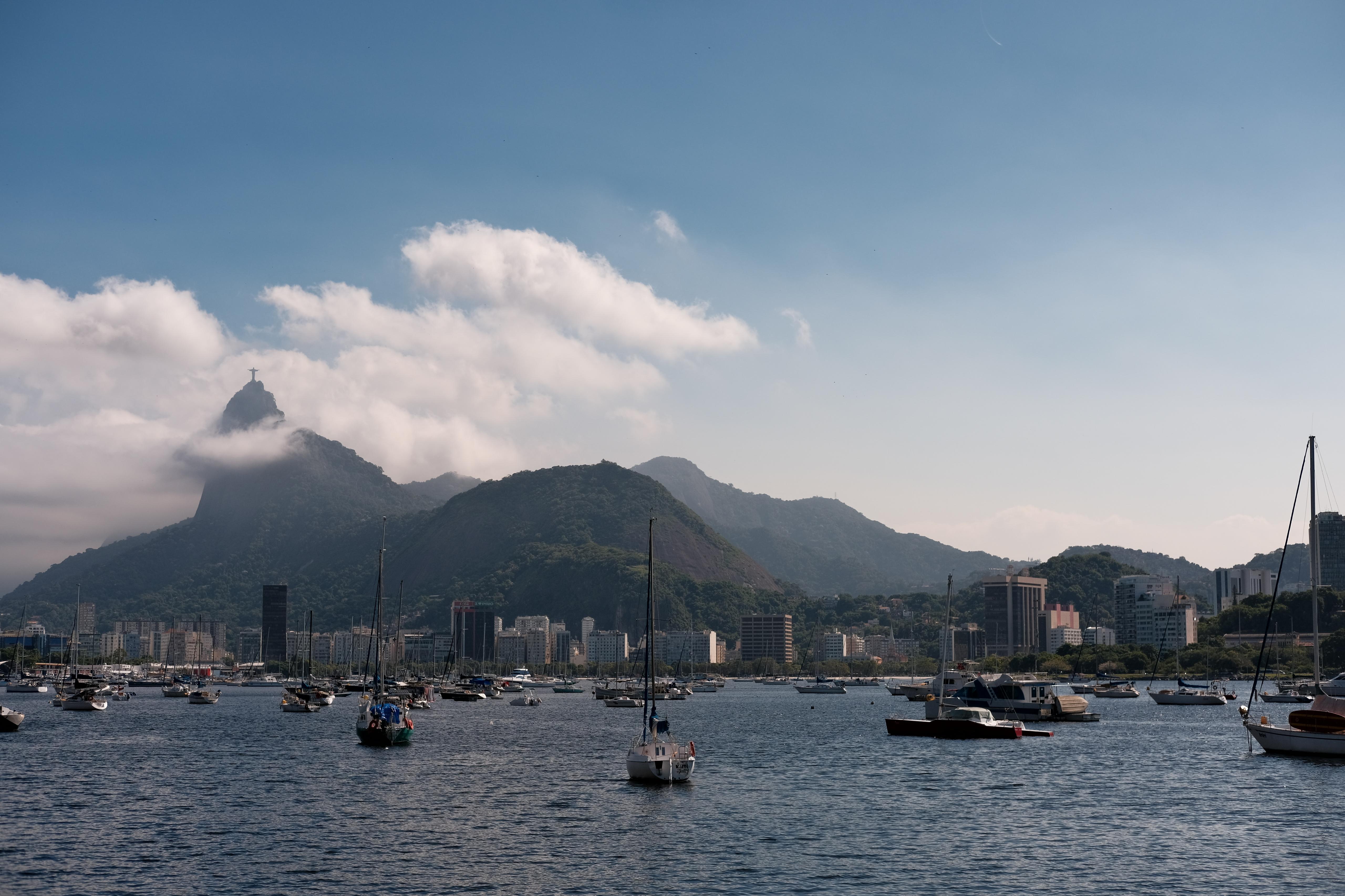 View of boats on the water with mountains in the background on a clear day.
