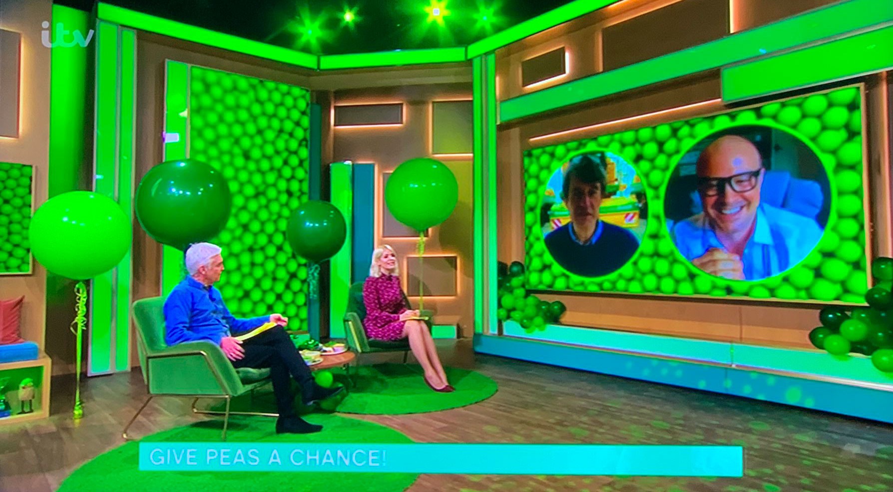This Morning broadcast displayed on a flat screen. There are lots of vibrant green pea graphics on screen, along with Phillip Schofield, Holly Willoughby, Stephen Francis and Dale Pinnock