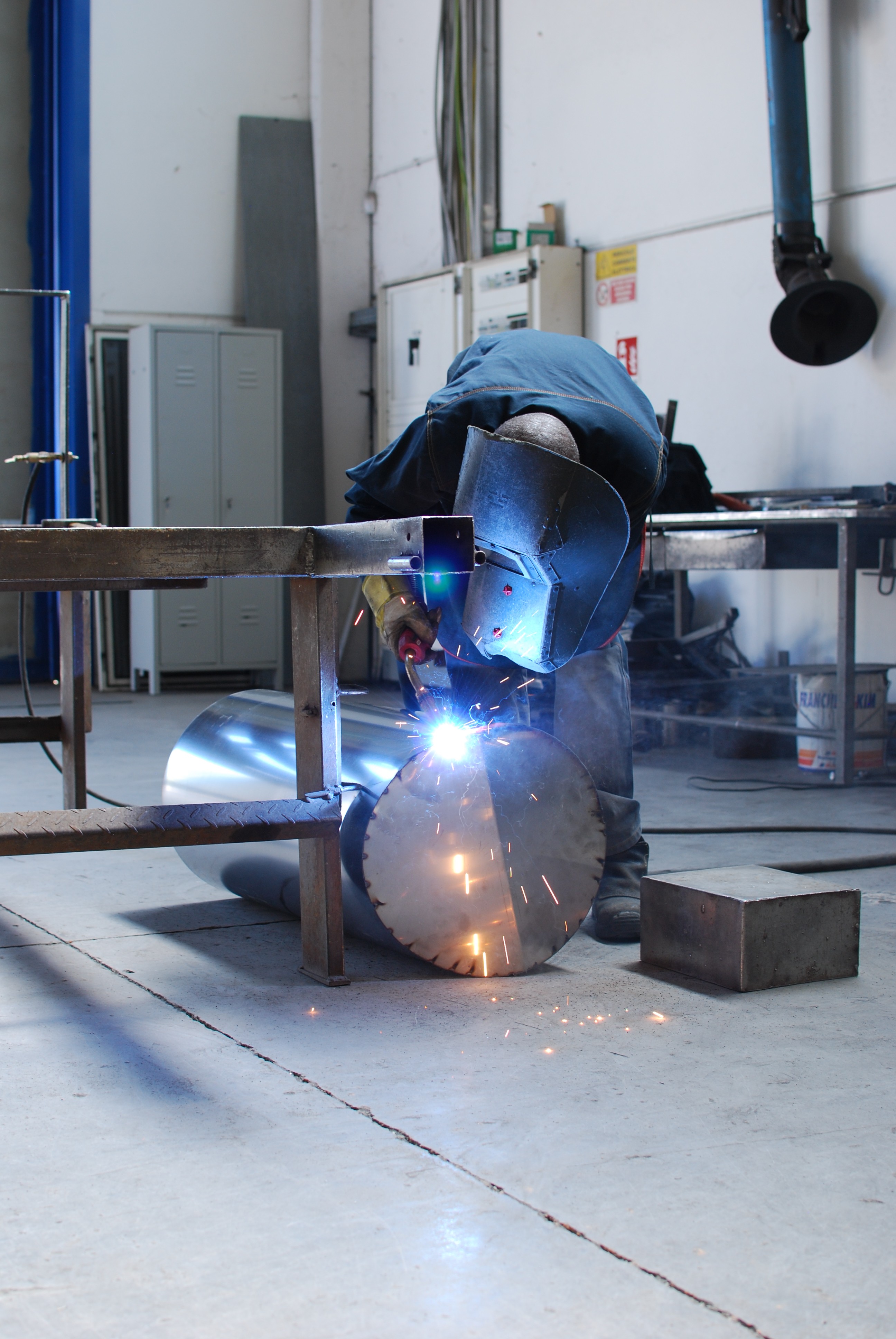 welder working on a piece of metal in a factory
