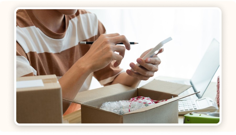 Person checking package with a smartphone