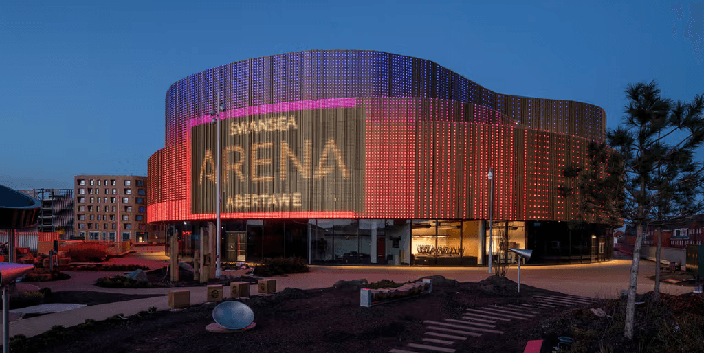 Swansea Arena lit with colorful lights.