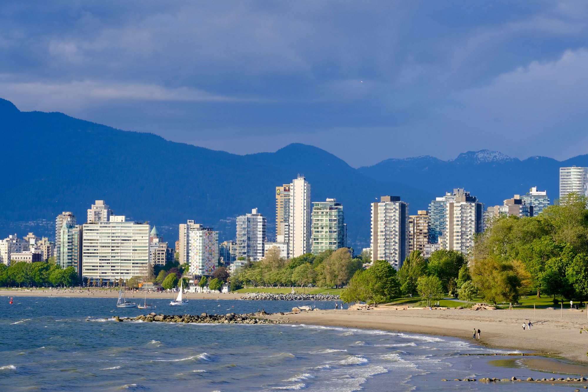 Vancouver skyline seen across the water with mountains behind it