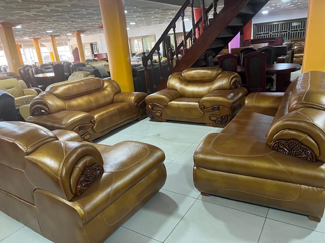 a gray couch with a wooden base on a gray background