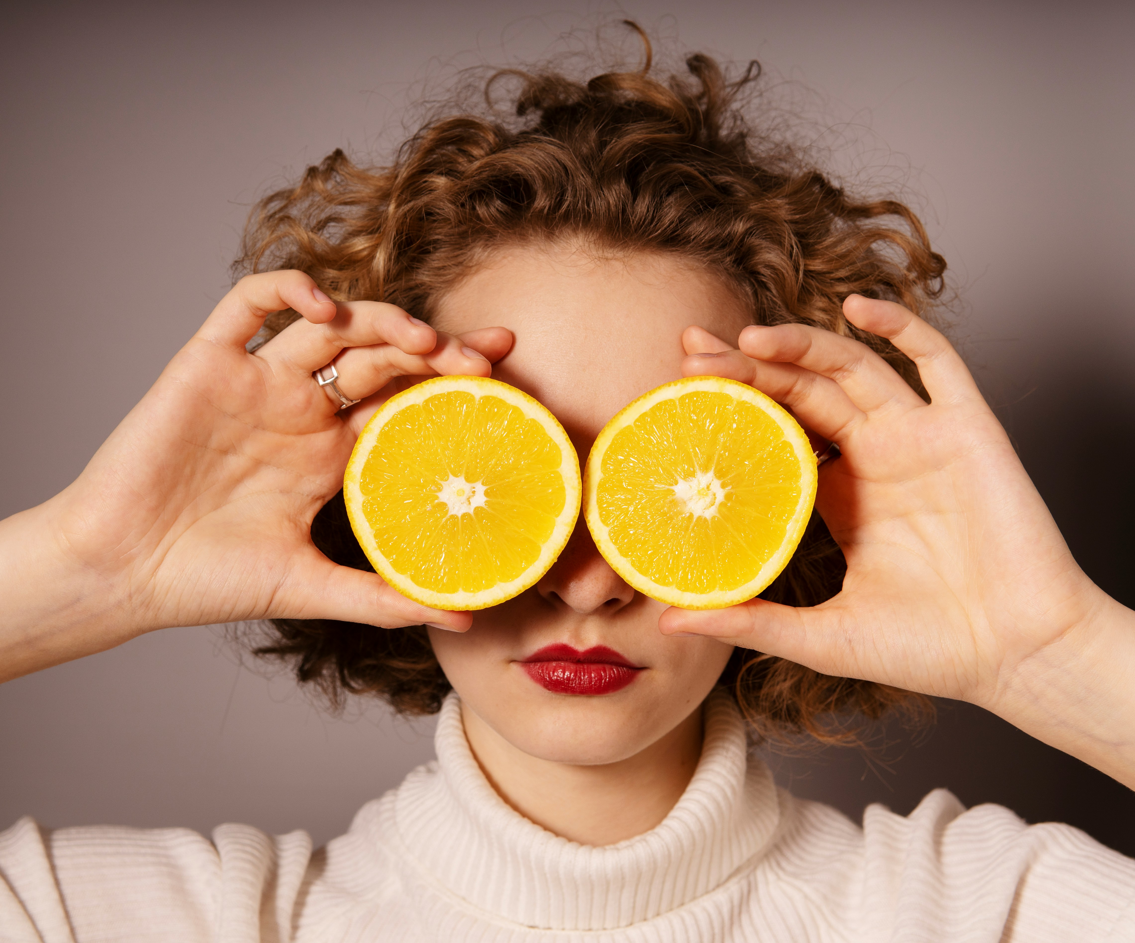 lady with sliced oranges over eyes