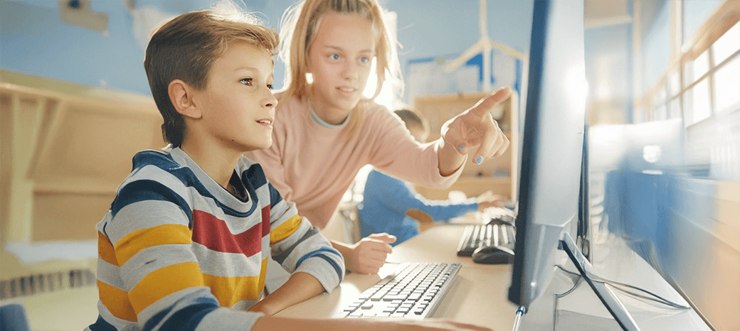 Students creating digital illustrations and graphic design projects in after school digital arts enrichment class