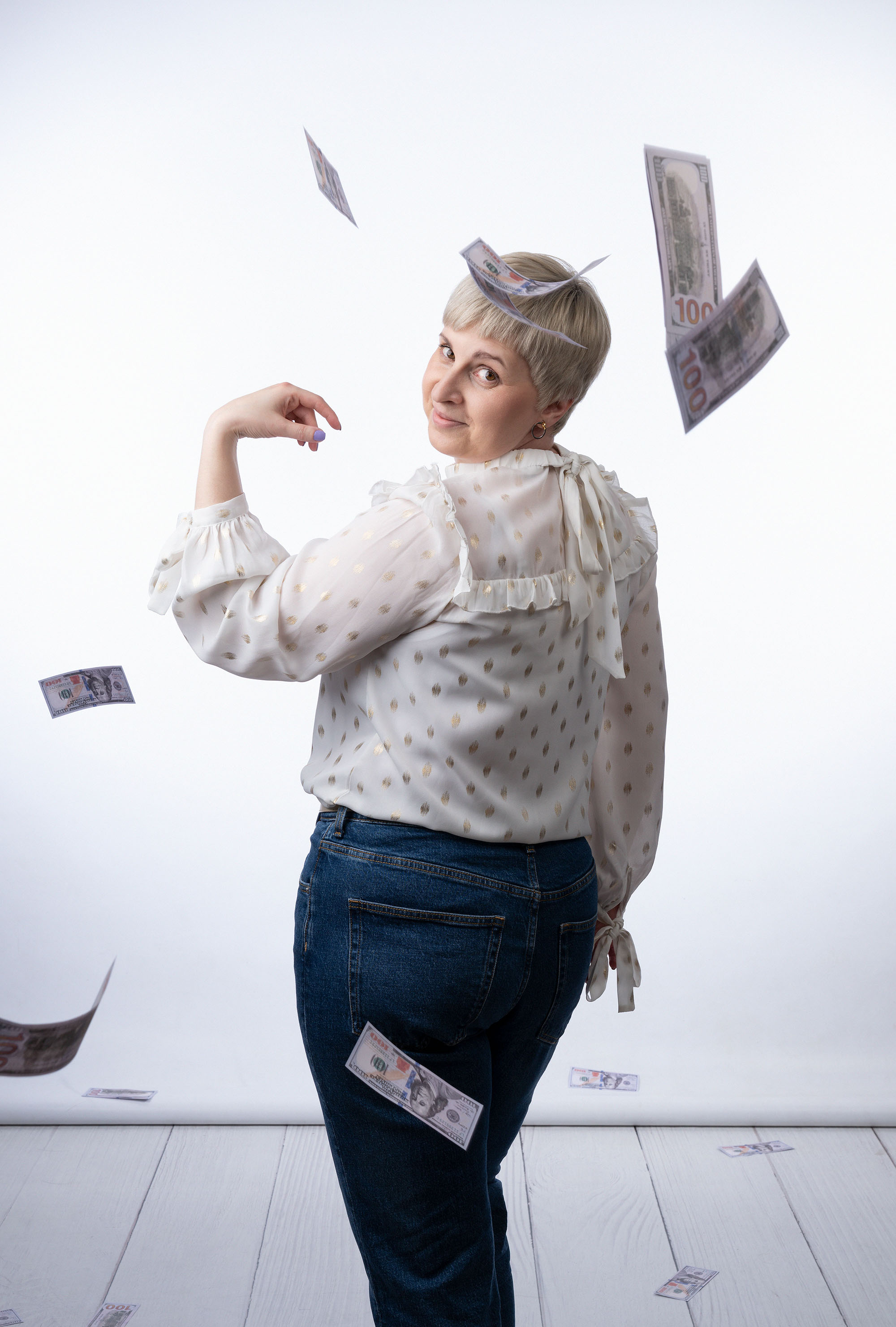 Woman looking behind and throwing money behing her back