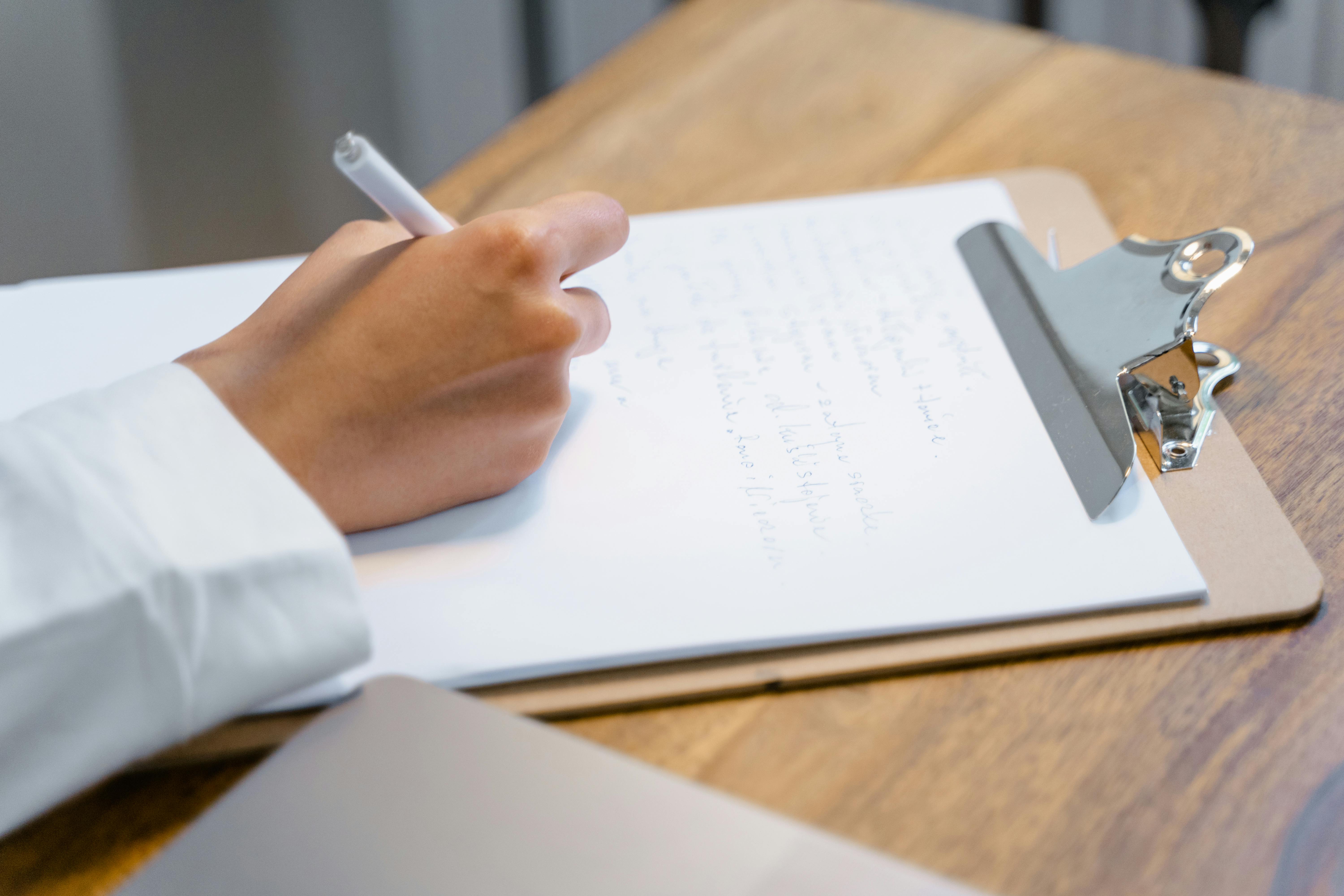 A Person Writing on a Paper