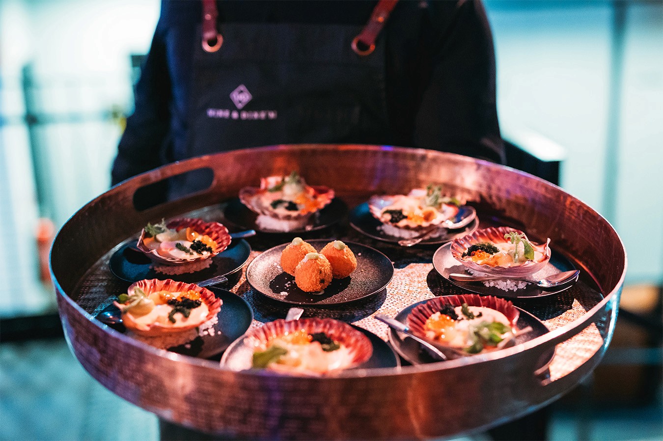 Waiter serving a variety of canapes