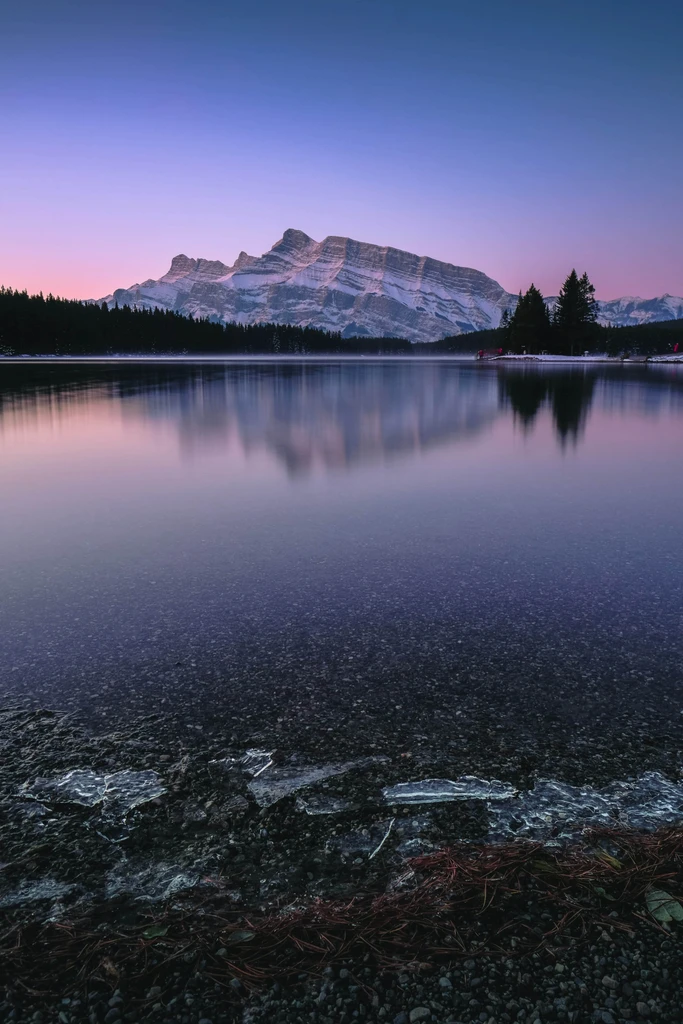 A lake with a mountain in the distance