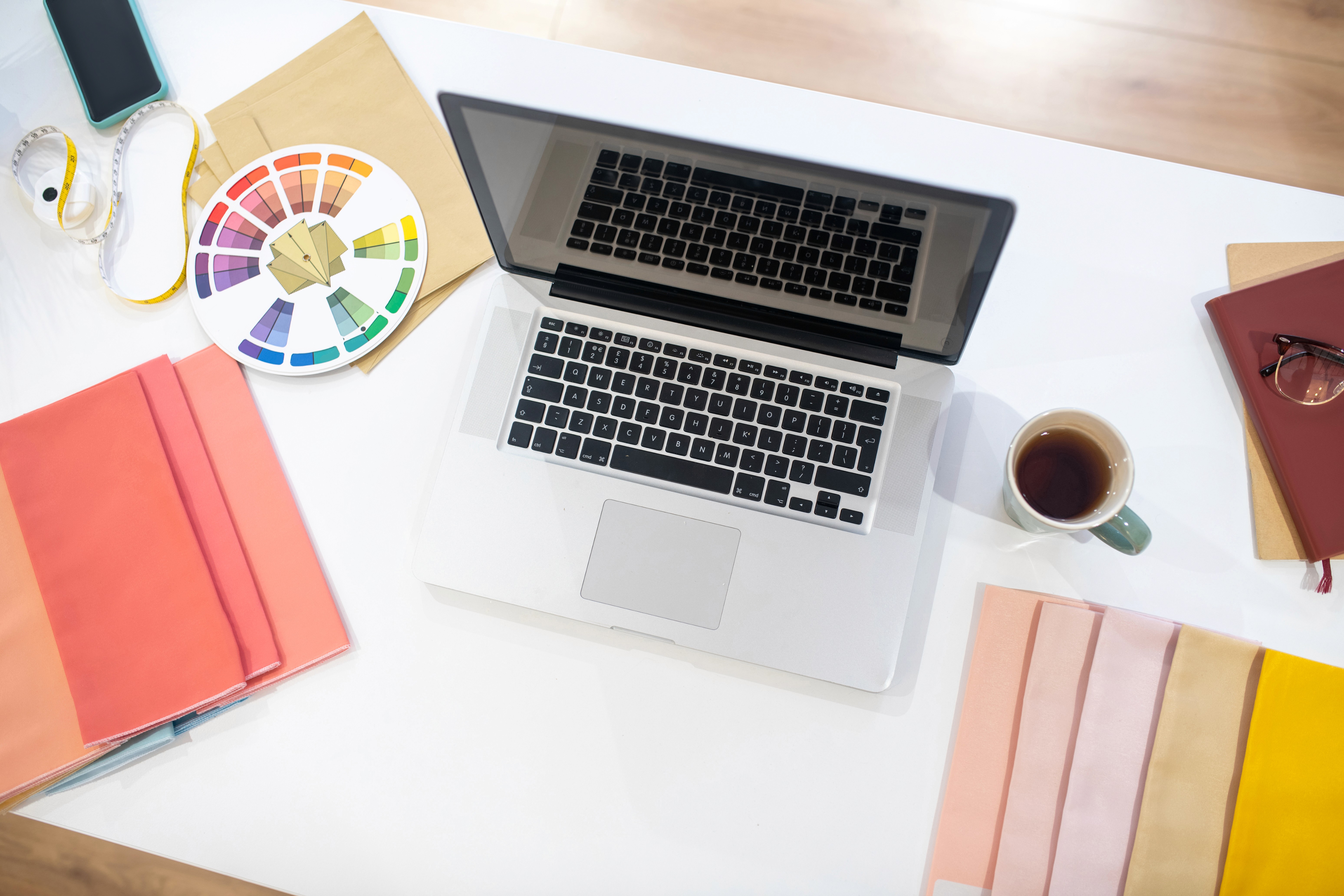 A laptop and everyday essentials on a bright desk