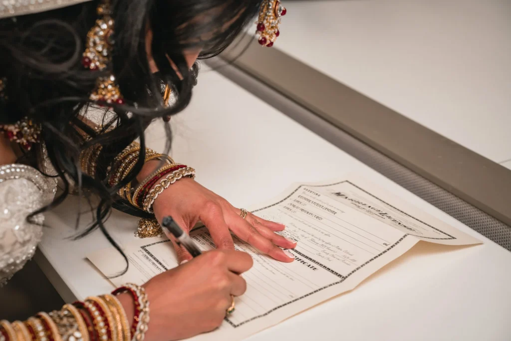 Person signing a marriage document