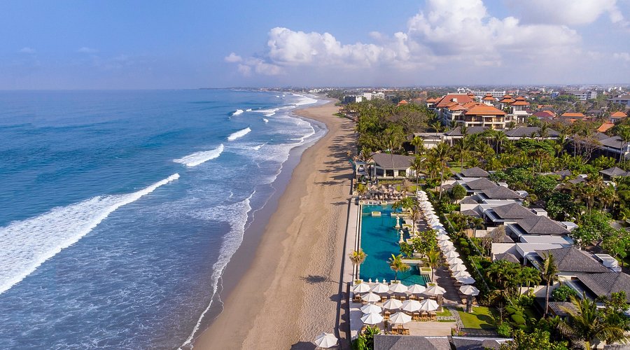 Aerial view of beachfront resorts in Seminyak, showcasing premium real estate opportunities in Bali.