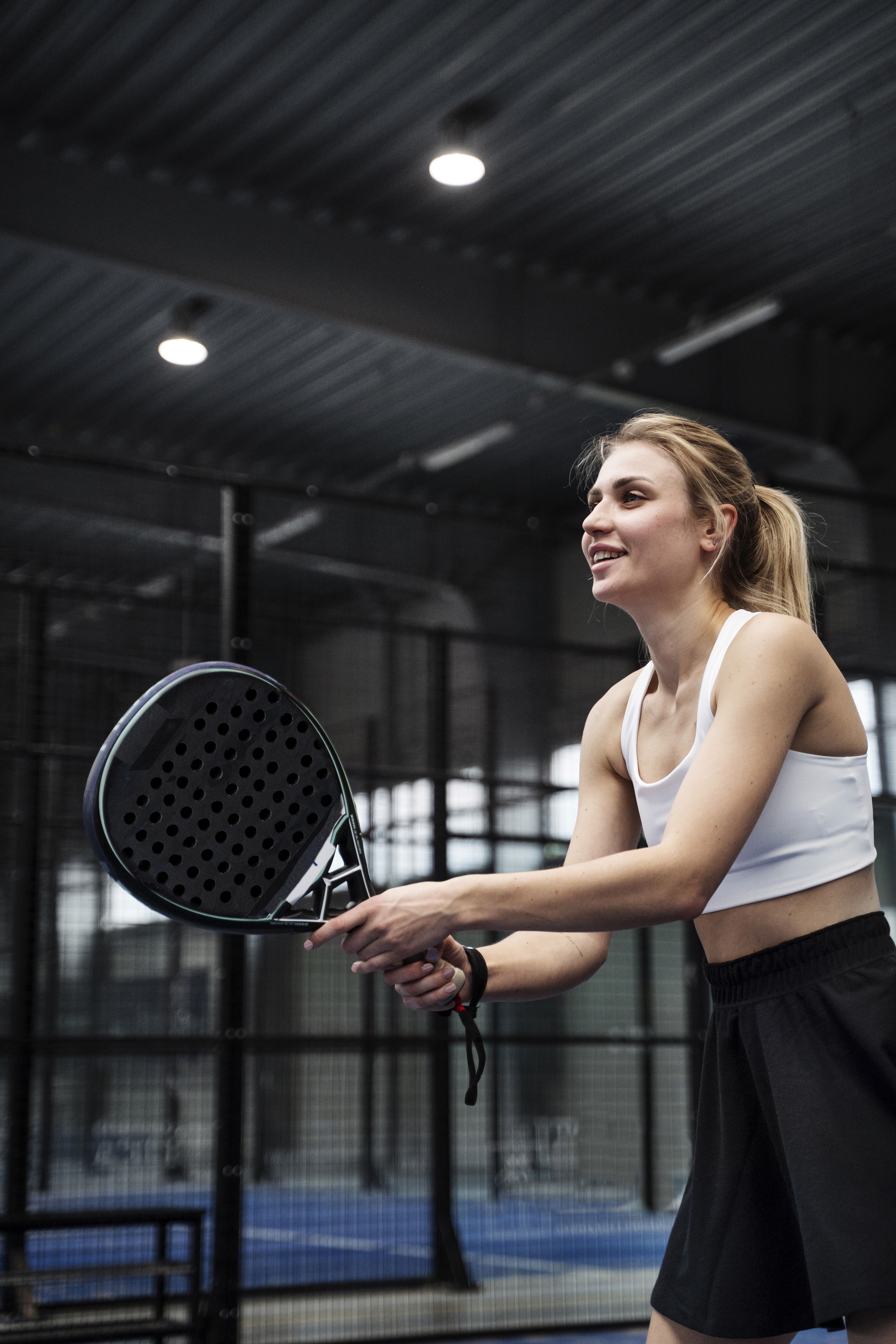man in gray hoodie and blue denim jeans standing on brown wooden parquet flooring