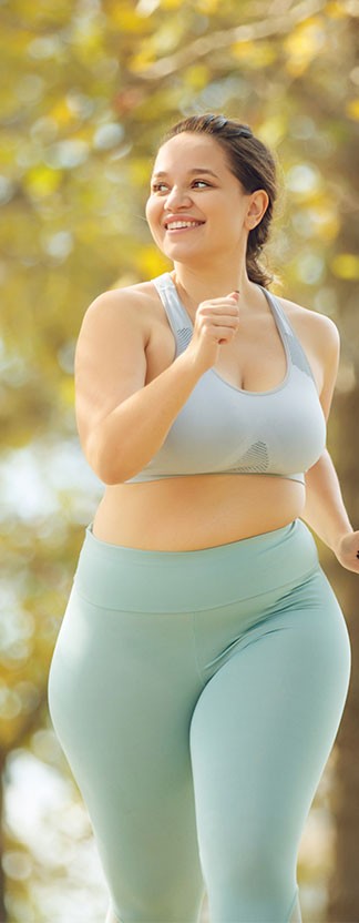 Woman running outodoors with colorful trees and leafs