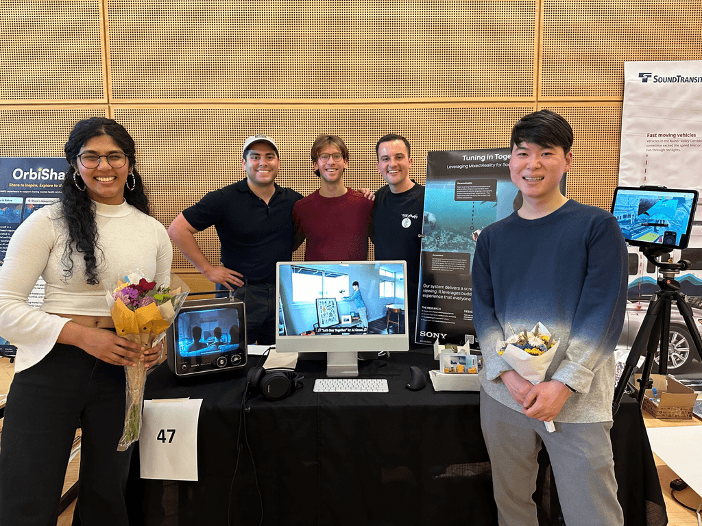 My team and I standing at our booth during our master's showcase.