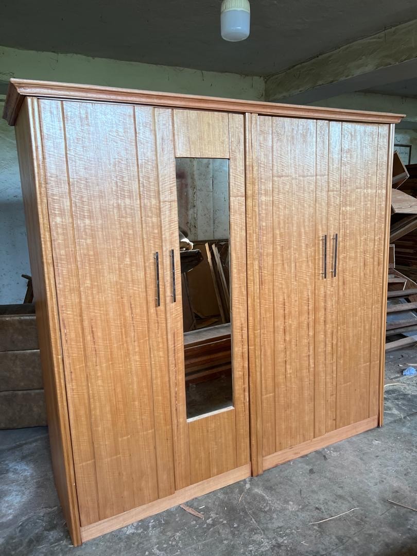 a gray couch with a wooden base on a gray background