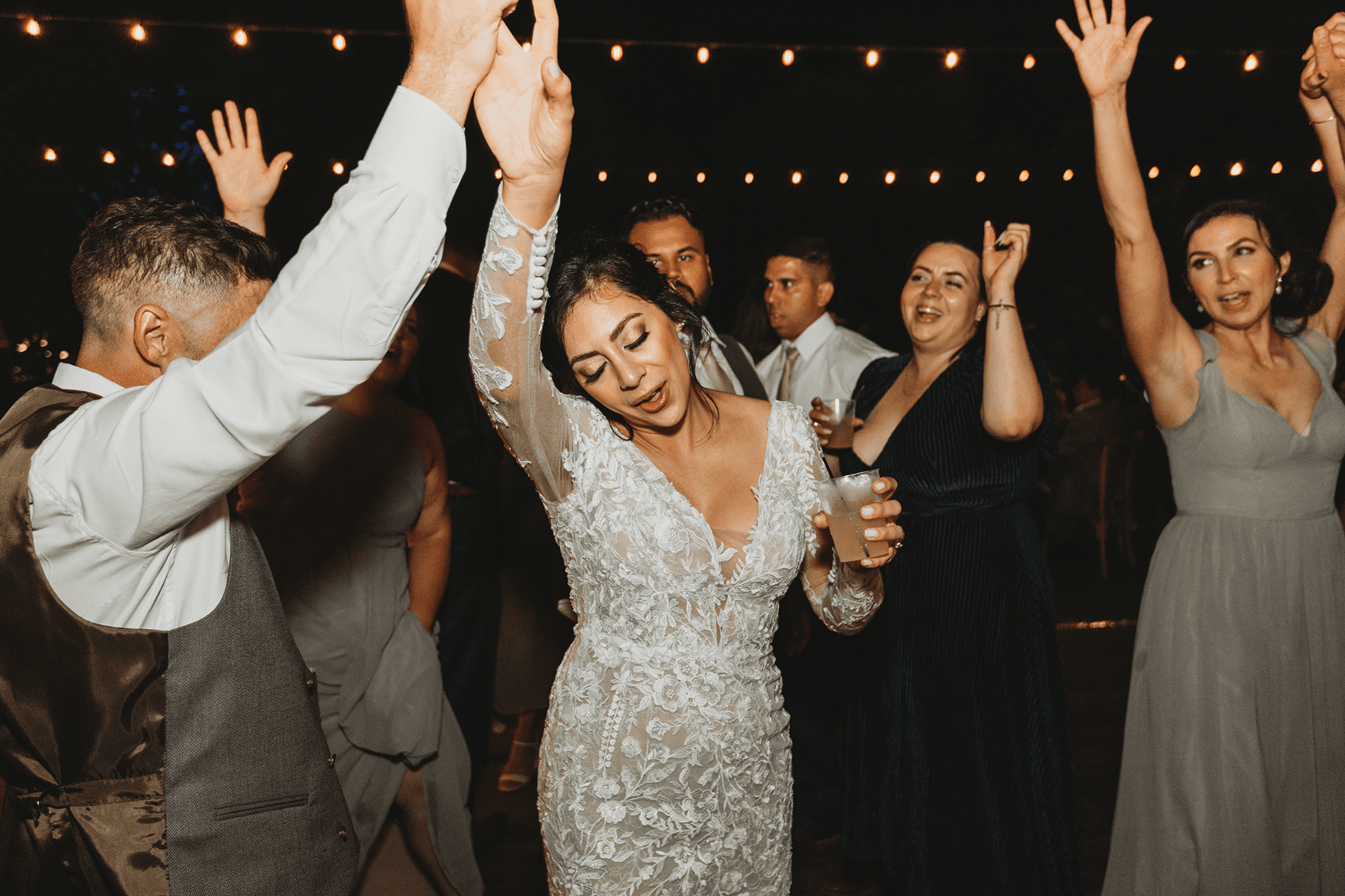 Flat lay wedding details with bouquet, rings, and sparkling bridal heels