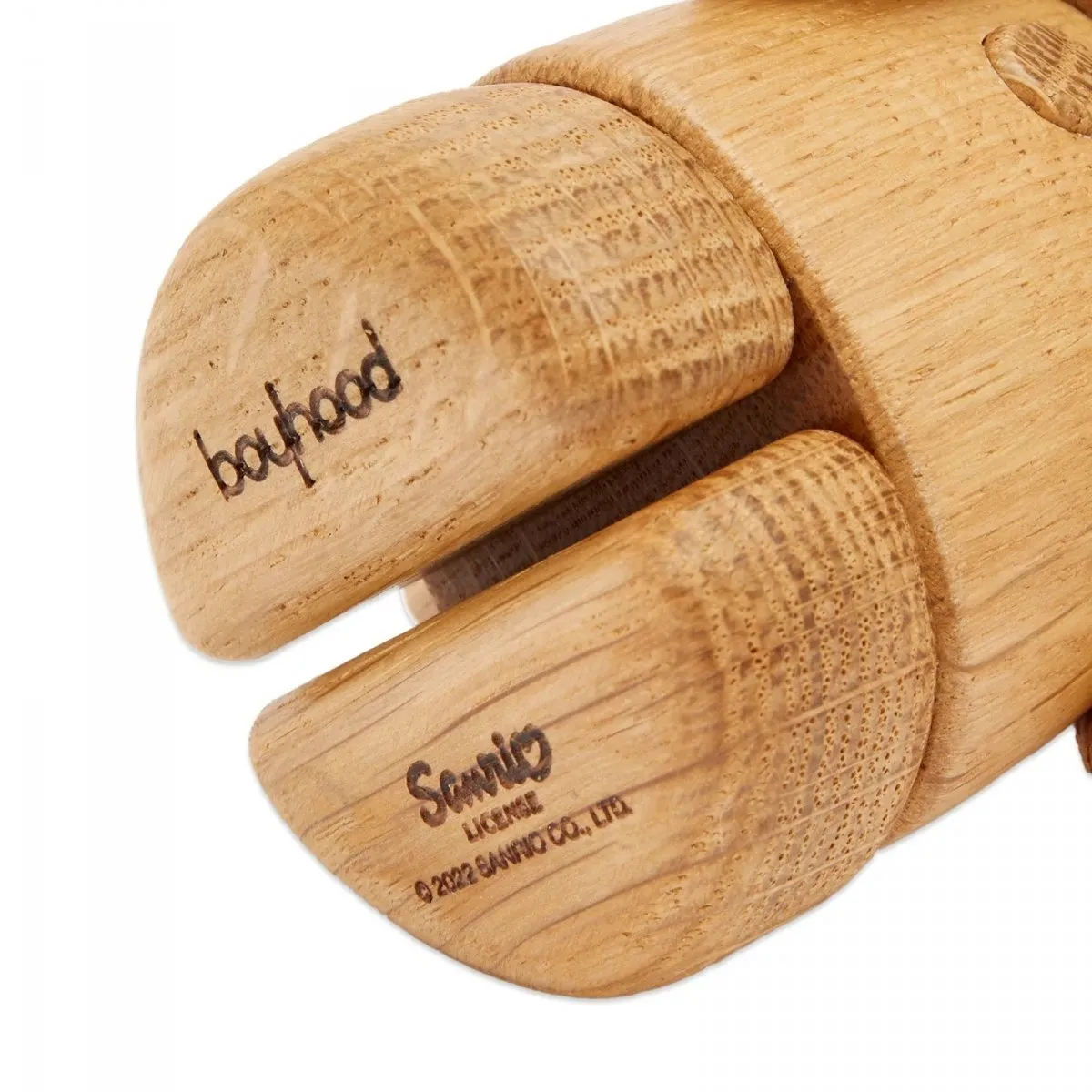 Close-up of Boyhood Hello Kitty wooden figurine showing simplified sculptural details and crafted wooden finish