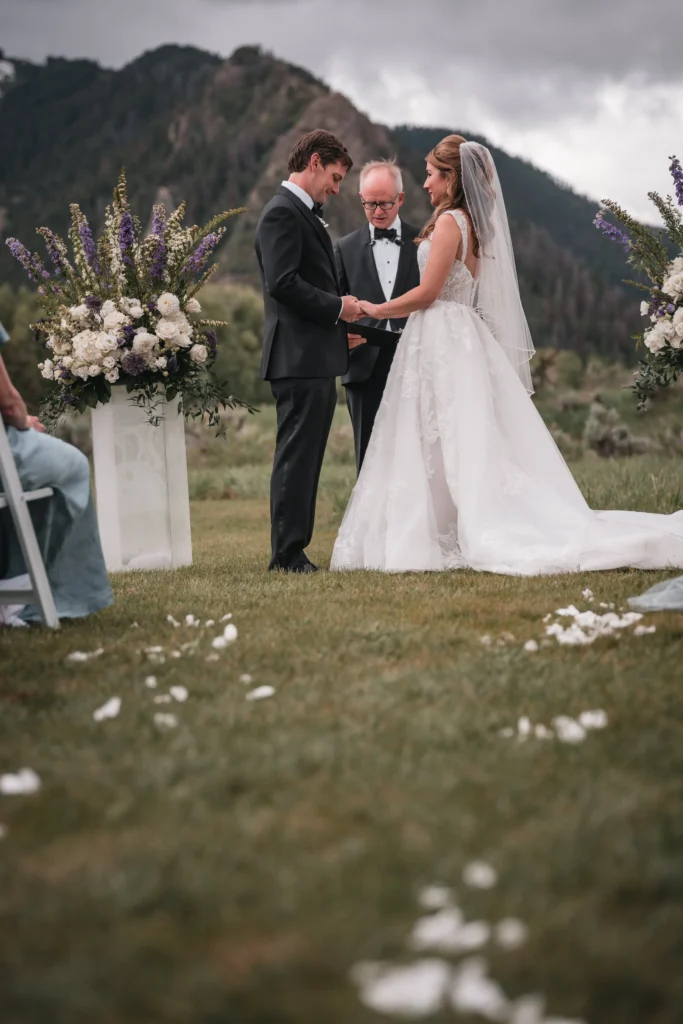 Couple exchanging vows during outdoor Aspen Meadows Resort Wedding ceremony