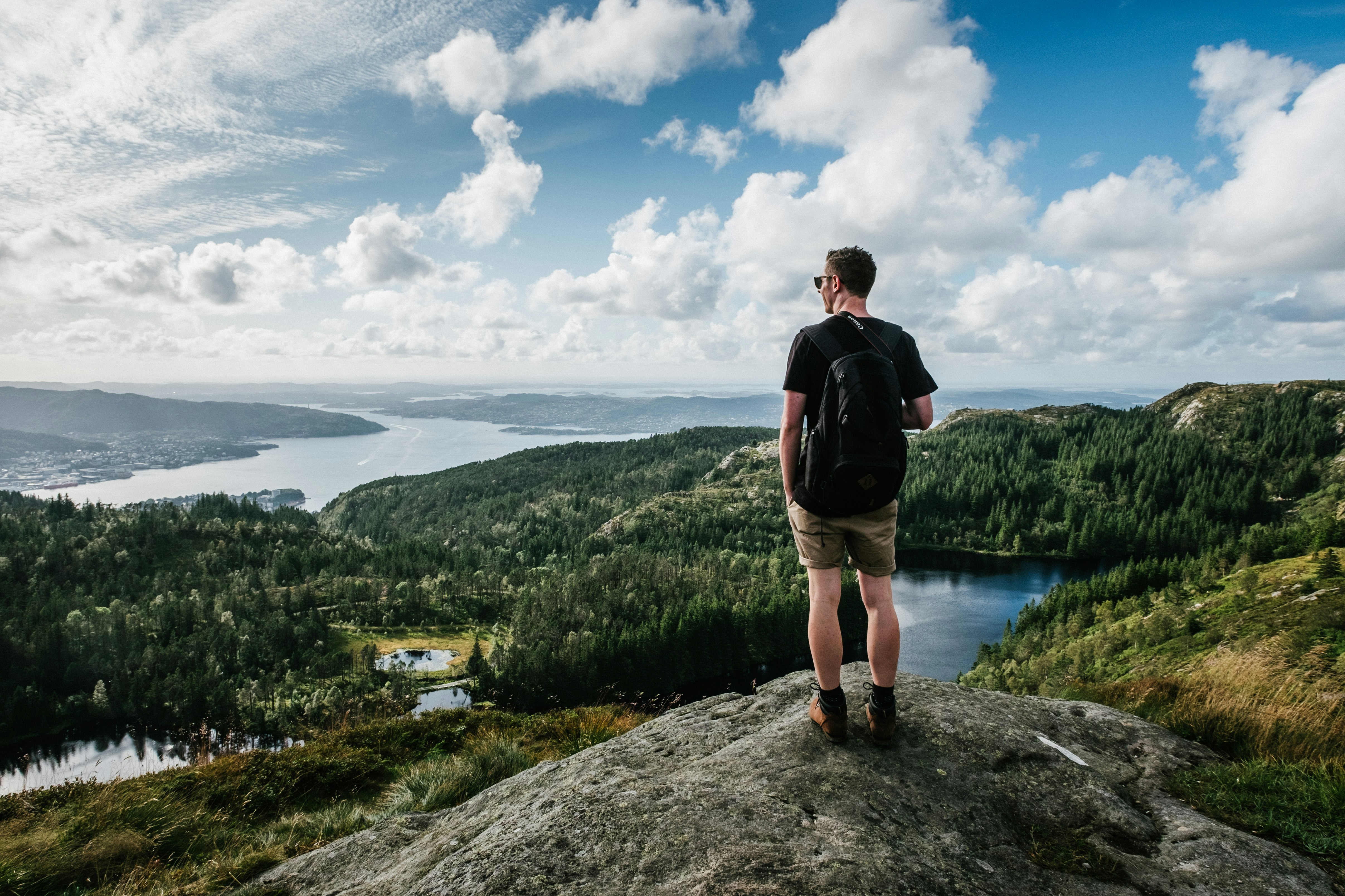 man on top of mountain - Fall hiking outfit