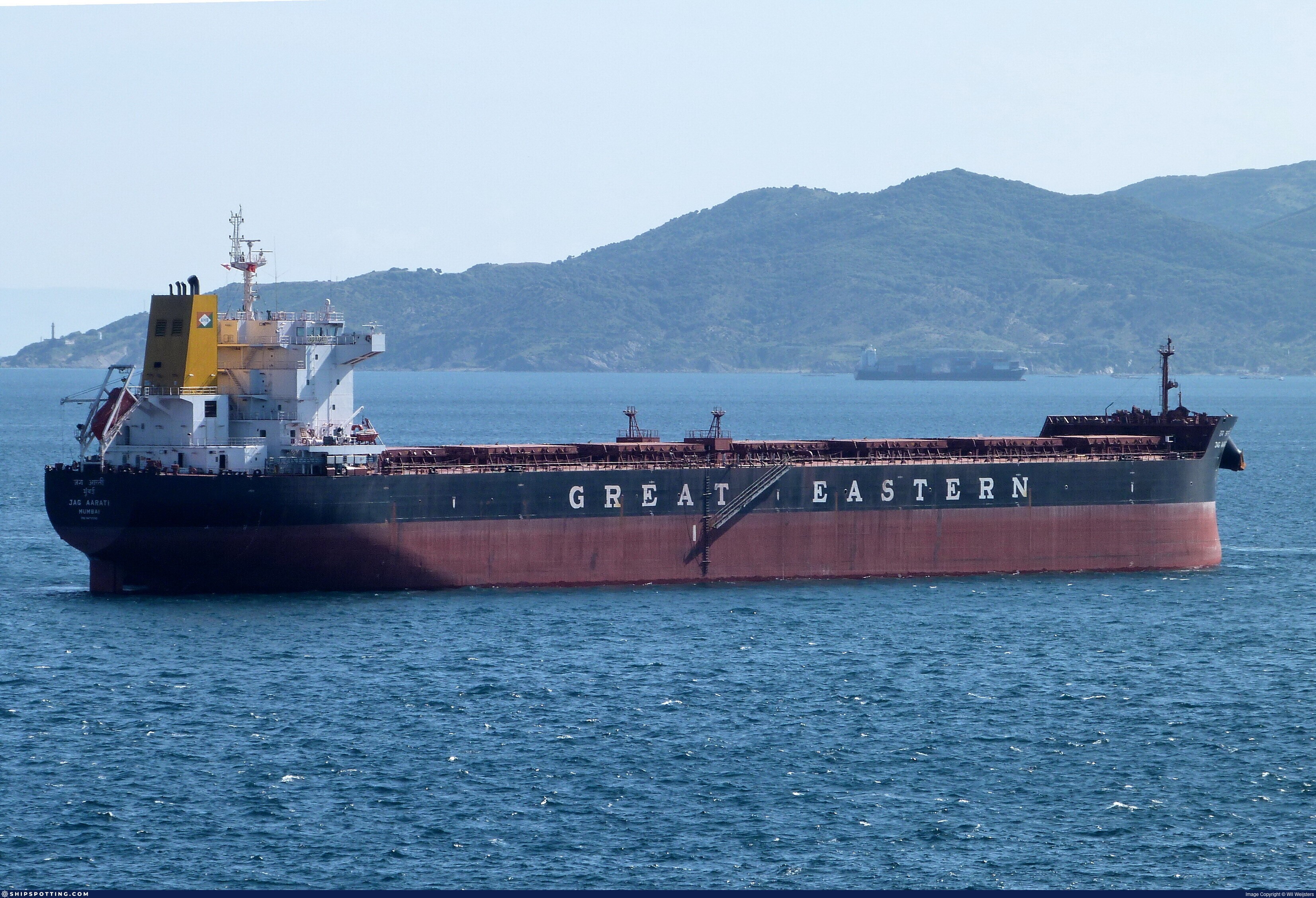 M/V JAG AARATI (IMO 9478200) bulk carrier at anchor — side profile highlighting full cargo hold configuration and hull structure during post-cleaning sugar trade readiness.